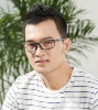 Handsome young man sitting on chair at his desk